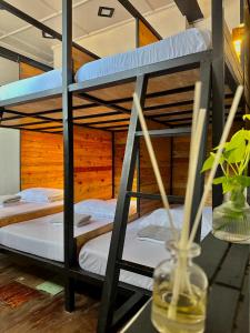 a bunk bed room with two bunk beds and a table at Yellow Umbrella Hostels in Cebu City