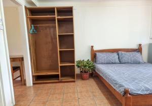 a bedroom with a bed and a book shelf at Panatina Hilltop Downstairs Unit in Honiara