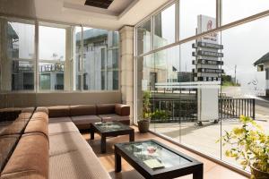 a living room with a couch and a large window at Oak Ray Misty Hills in Nuwara Eliya