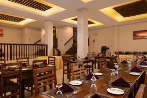a dining room with wooden tables and chairs at Oak Ray Misty Hills in Nuwara Eliya