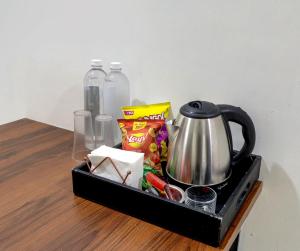 a tray with a tea kettle on a table at Hotel CINCO PRIME -PREMIUM ROOMS in Secunderabad