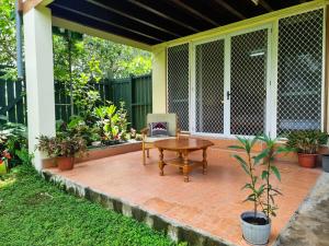 a patio with a table and a chair at Panatina Hilltop Downstairs Unit in Honiara +4 photos