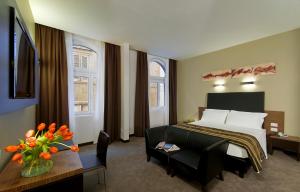 a hotel room with a bed and a table and a couch at Hotel Rinascimento in Rome