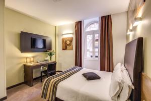 a hotel room with a bed and a desk at Hotel Rinascimento in Rome +33 photos