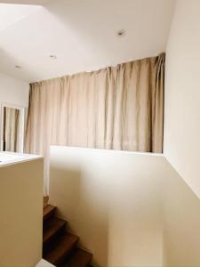 a staircase in a room with a curtain at la MERéMOI - Duplex Knokke with balcony and free parking in Knokke-Heist