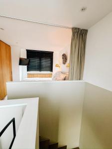 a small room with a bed and a window at la MERéMOI - Duplex Knokke with balcony and free parking in Knokke-Heist