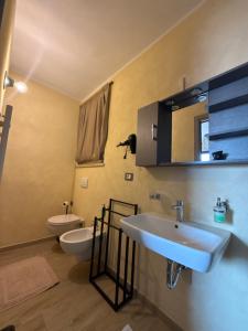 a bathroom with a sink and a toilet and a mirror at La reggia di Gianfry in Fermo +85 photos