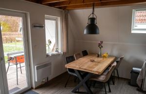 a dining room with a wooden table and chairs at De Eekhoorn in Gramsbergen