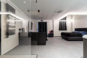 a living room with a couch and a bed at SUITE Esbly, Jacuzzi, Terrasse, Disneyland in Esbly +27 photos