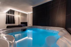 a bath tub with blue lighting in a bathroom at SUITE Esbly, Jacuzzi, Terrasse, Disneyland in Esbly