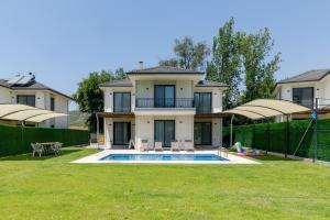 a house with a swimming pool in a yard at Holiday Villa Lena in Köyceğiz
