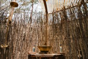 a bathroom with a wall covered in nets at Bunduz Mara in Sekenani