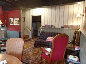 a living room with a couch and a table and chairs at Bramfam in Gresse-en-Vercors