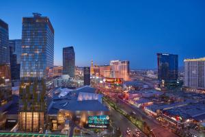 a view of a city skyline at night at Waldorf Astoria Las Vegas in Las Vegas