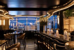 a restaurant with a view of the city at Waldorf Astoria Las Vegas in Las Vegas
