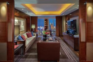 a living room with a couch and a television at Waldorf Astoria Las Vegas in Las Vegas