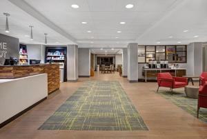 a lobby of a hospital with red chairs and a waiting room at Hampton Inn Westfield in Westfield