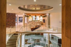 a staircase in a house with a boat on it at Higuerón Hotel Málaga, Curio Collection by Hilton in Fuengirola