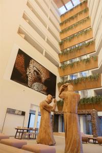 two statues of women standing in a building at Higuerón Hotel Málaga, Curio Collection by Hilton in Fuengirola +83 photos