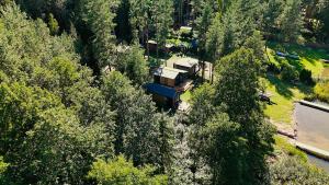 an aerial view of a house in the middle of trees at Makosieje Resort-20m od brzegu,wi-fi ,widok na jezioro in Makosieje