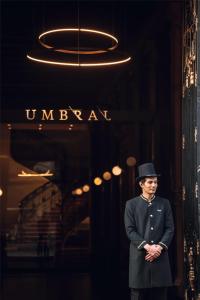 a man in a top hat standing in front of a building at Umbral, Curio Collection By Hilton in Mexico City +100 photos