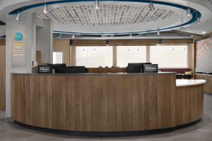 an office lobby with a reception desk with two laptops at Tru By Hilton Stockbridge in Stockbridge