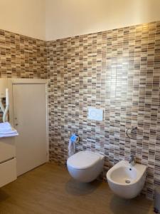 a bathroom with a sink and a toilet in it at Elegant mini appartments Floridia close to the center private parking in Taormina