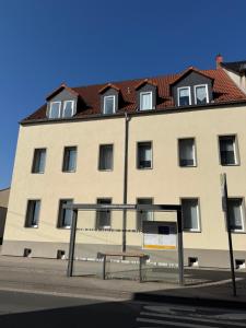 a large building with a bench in front of it at StayHere24 Maisonette-Wohnung mit großem Garten in Leipzig +11 photos