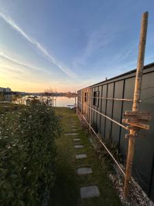 a train parked next to a fence next to a body of water at Kolokemp pri súkromnom jazere Boldog in Senec
