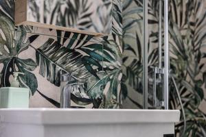 a bathroom with a sink and a plant wallpaper at Casa de Colores en Corfu! in Corfu +12 photos