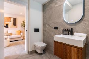 a bathroom with a white sink and a mirror at Apartamentos Plaza España - Enjoy Sevilla in Seville +193 photos