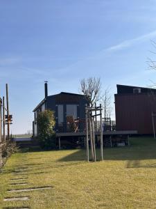 a house with a picnic table in front of it at Kolokemp pri súkromnom jazere Boldog in Senec