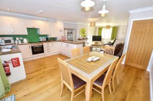 a kitchen and dining room with a table and chairs at 18 Marriotts Way in Sheringham +20 photos