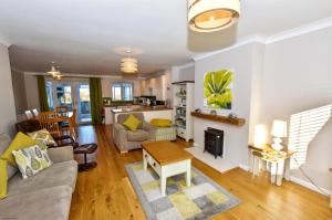 a living room with a couch and a fireplace at 18 Marriotts Way in Sheringham