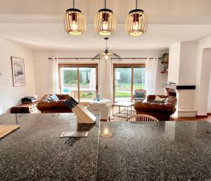 a living room with couches and a table at Villa Mar & Surf • Piscina privada in Atouguia da Baleia
