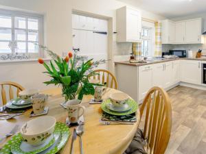 a kitchen and dining room with a wooden table and chairs at 2 Bed in Alford oc-77637 in Rigsby