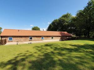 a brick building with a large grassy field in front of it at 3 Bed in Alford oc-55963 in Rigsby