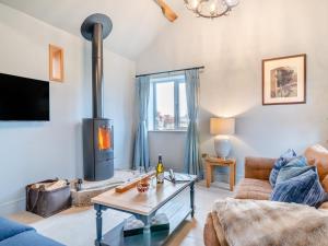 a living room with a couch and a fireplace at 1 Bed in Gloucester oc-95793 in Tirley