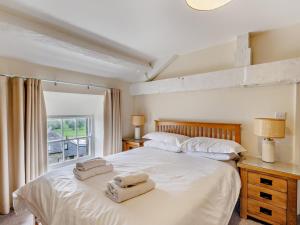 a bedroom with a white bed with two towels on it at 6 Bed in Buxton oc-77369 in Longnor