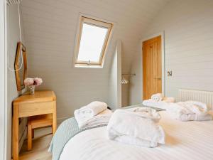 two beds with towels on them in a room at 2 Bed in Tain oc-81339 in Nigg