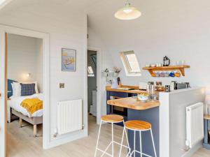 a small kitchen with a table and stools in a room at 2 Bed in Tain oc-81339 in Nigg +7 photos