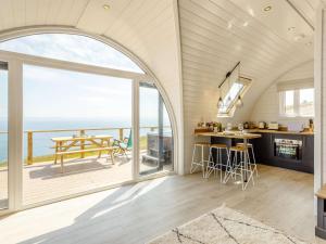 an open kitchen and dining room with a view of the ocean at 1 Bed in Tain oc-81337 in Nigg