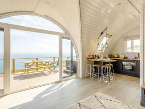an open kitchen and dining room with a view of the ocean at 1 Bed in Tain oc-81338 in Nigg