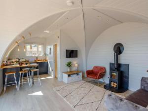 an open living room with a stove and a kitchen at 1 Bed in Tain oc-81338 in Nigg