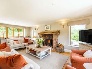a living room with a couch and a fireplace at 4 Bed in Wrexham oc-87675 in Chirk