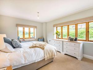 a bedroom with a white bed and windows at 4 Bed in Wrexham oc-87675 in Chirk