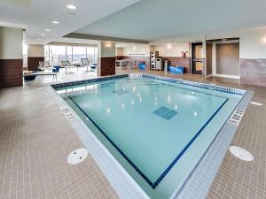a large swimming pool in a hotel room at DoubleTree by Hilton Edmonton Downtown in Edmonton