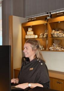 a woman sitting at a counter in a store at Bommersvik Hotell & Konferens in Järna