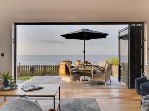 a living room with a patio with an umbrella at 2 Bed in Anstruther oc-66733 in Pittenweem