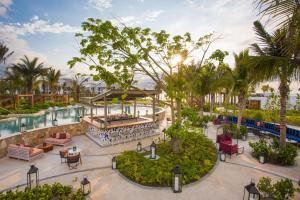 an aerial view of a resort with a pool and palm trees at Conrad Punta de Mita in Punta Mita